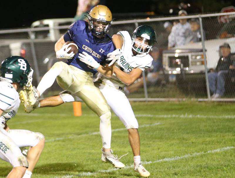 Marquette's Easton Debernardi comes up with a catch in the end zone over St. Bede's Jose De Le Torre on Friday, Sept. 26, 2025 at Gould Stadium in Ottawa.