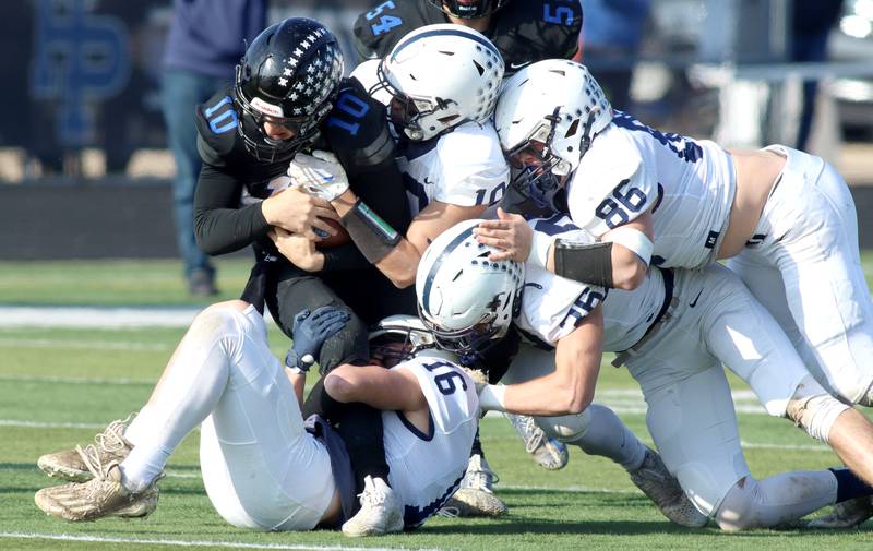 Cary-Grove’s Connor Mattran, Thomas Battaglia, Charlie Ciske, and Kyle Jarecki swarm Highland Park’s David Finfer in second-round IHSA Class 6A playoff action at Wolters Field in Highland Park Saturday.