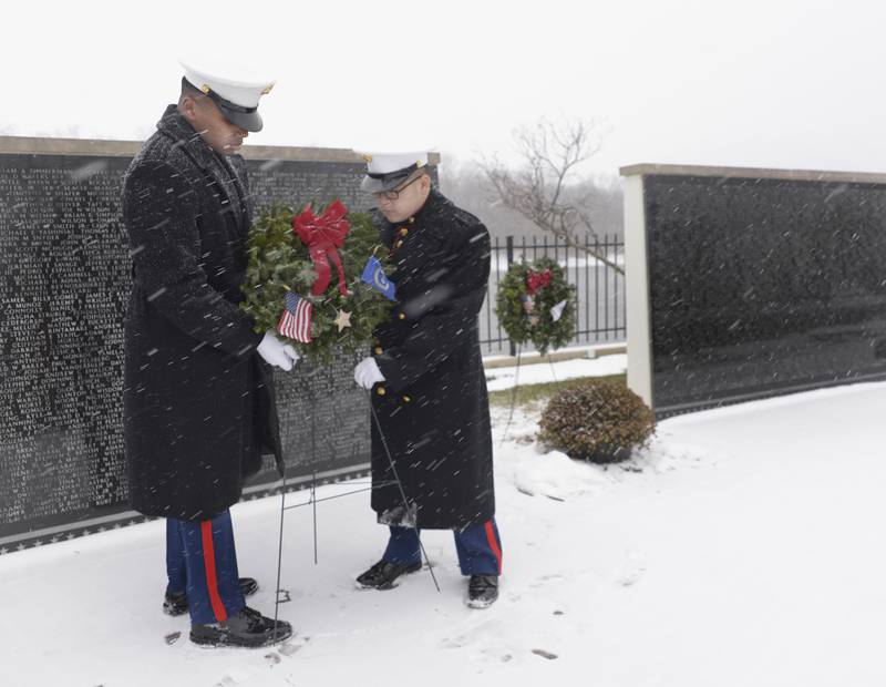 Members of the  U.S. Marine Corps Color Guard unit out of Joliet, place a wreath long the Middle East Conflicts Wall Memorial in Marseilles Saturday before the Wreaths Across America ceremony.