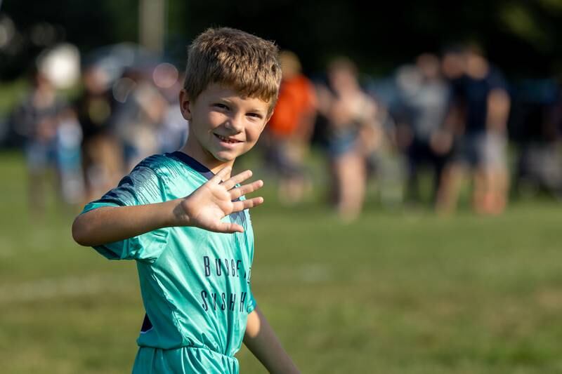 Grady Nordtvedt waves at family at the opening day ceremony of youth soccer on Saturday, Aug 16, 2025, at Peck Park in Ottawa.