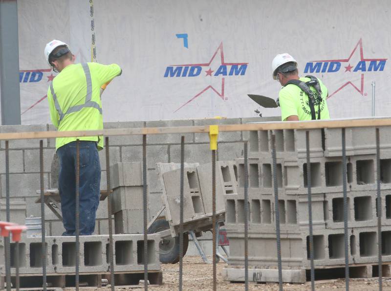 Crews from MCP Midwest build a wall out of masonry blocks on the new Henry-Senachwine High School academic wing addition on Monday, June 9, 2025 in Henry.