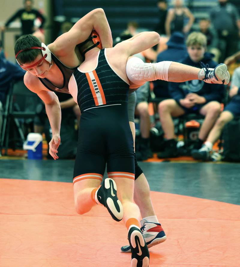 DeKalb’s Hudson Ikens lifts Lake Park’s Malsymilian Wala Wednesday, Nov. 27, 2024, during their 150 pound match at DeKalb High School. Ikens went on to win by a technical fall.