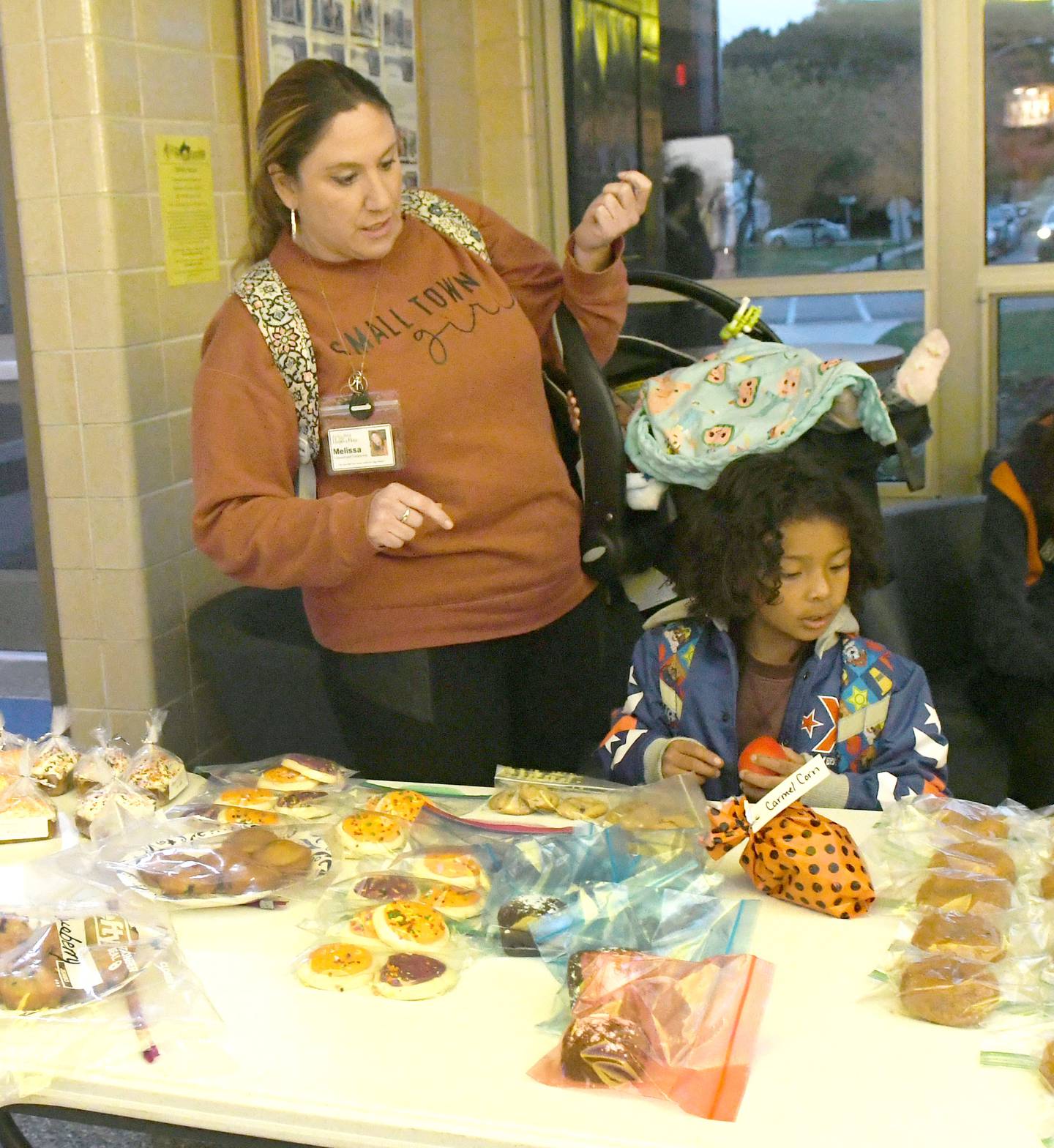 Melissa Ryan of Milledgeville looks over baked goods for sale at the Polo volleyball team's fundraiser for two Milledgeville teens critically injured in an auto accident on Sunday, Oct. 9.