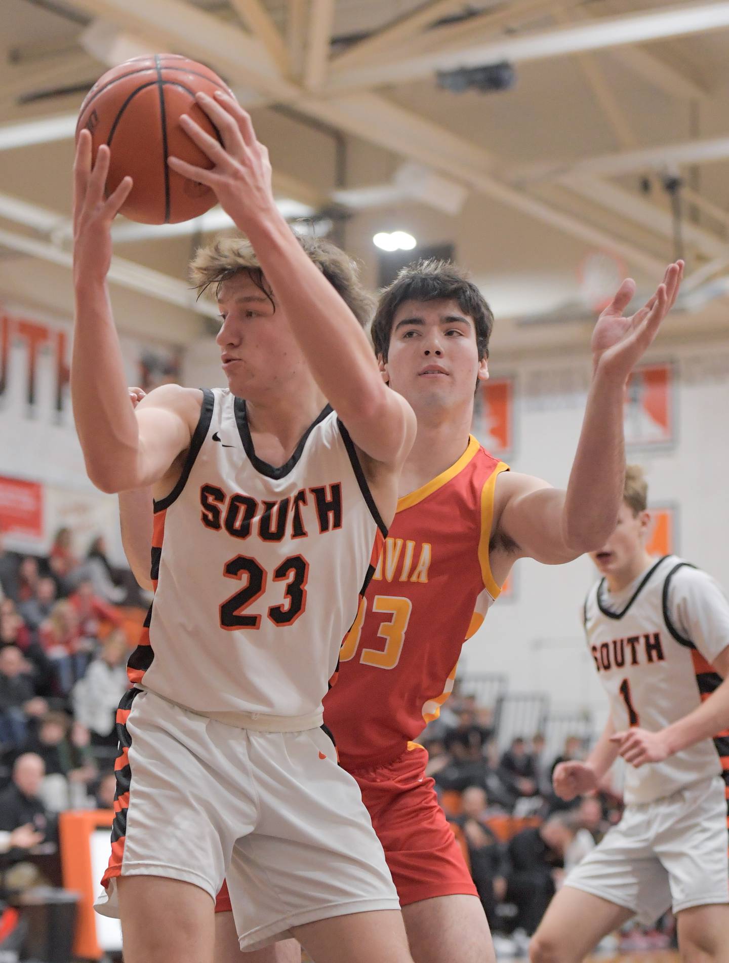 Wheaton-Warrenville South's Max O’connell (23) rebounds the ball against Batavia's Ben Fiegel (33) during a game in Wheaton on Saturday, January 6, 2024.