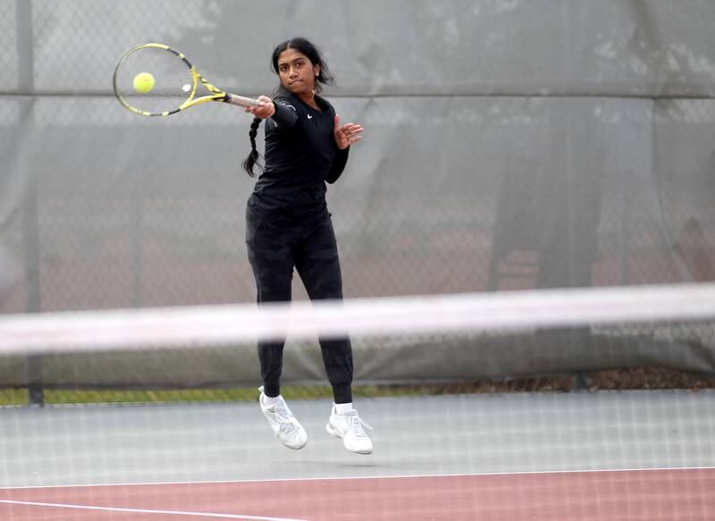 Fenwick’s Rachel Abraham returns the ball in a match with doubles partner Maeve Paris (not pictured) during the first day of the IHSA state tennis tournament at Palatine High School on Thursday, Oct. 20, 2022.
