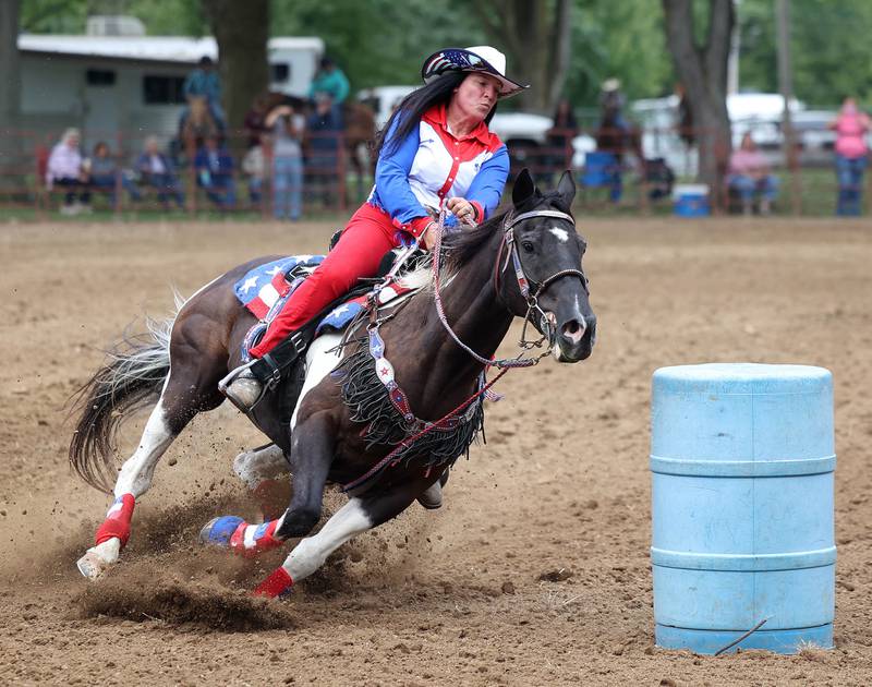 Stacy James and her horse compete in the barrel racing competition in the horse arena Wednesday, Sept. 3, 2025, on opening day of the Sandwich Fair.
