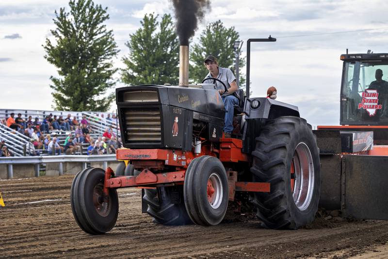 Jaceh Mahr, piloting the Curious George Case 1070, lifts the front wheels as he makes his pull Thursday, July 24, 2025, at the Lee County Fair in Amboy.