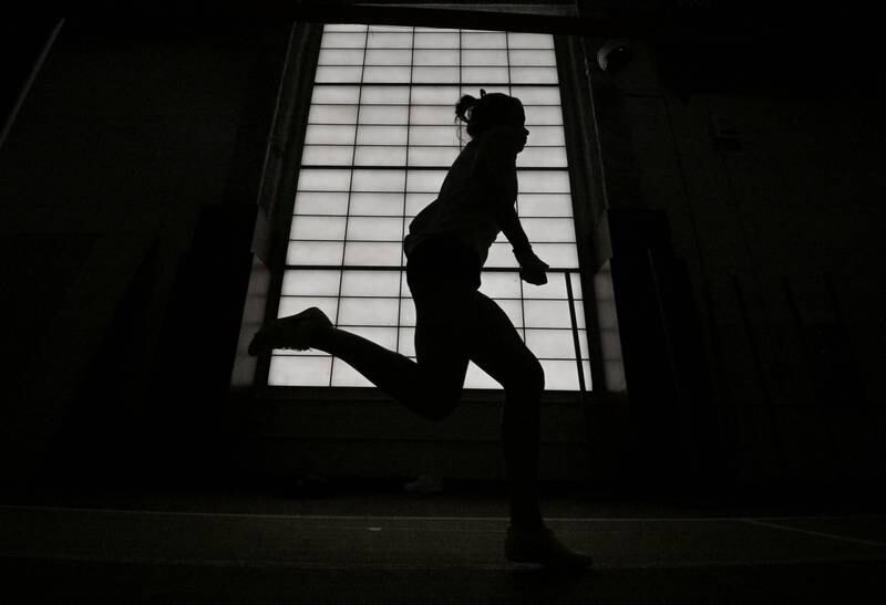 Wheaton Warrenville South’s Gracyn Mangelsen runs past frosted windows as she competes in the long jump at the Dukane Conference girls indoor track and field meet at Batavia High School on Friday, March 15, 2024.