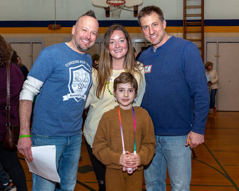 Event organizer Josh Thomas, (L). Parents Hilary and A.J. with Gwen at the St Baldricks Foundation event for Gwen Cola at Forest Road Elementary School in La Grange Park. March 23, 2023.