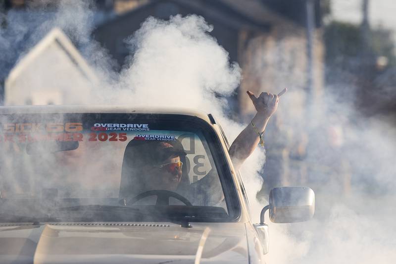A driver gestures as he smokes the tires Thursday, June 19, 2025, during Sick the Mag’s Epic Burnout show in Rock Falls.