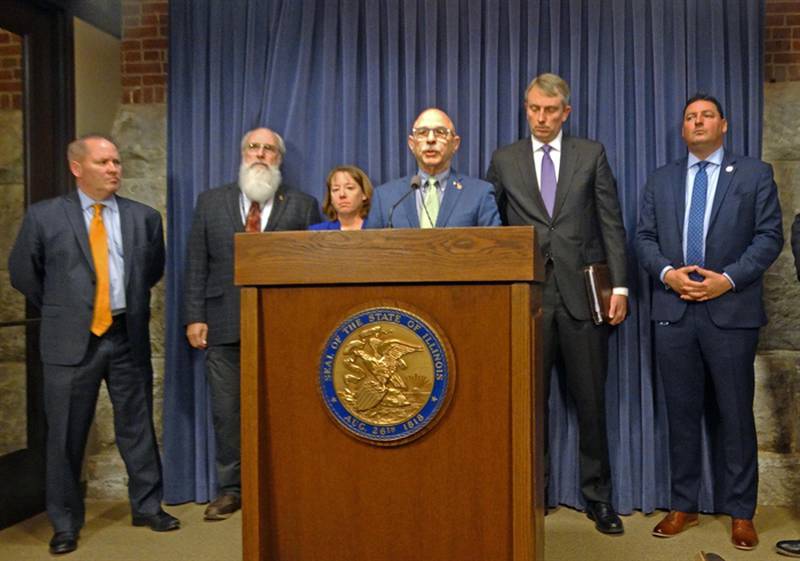 Republican state Rep. Dan Caulkins, center, joins other GOP lawmakers and officials from the Illinois State Rifle Association to discuss an upcoming Illinois Supreme Court review of a decision overturning parts of a recently passed assault weapons ban.