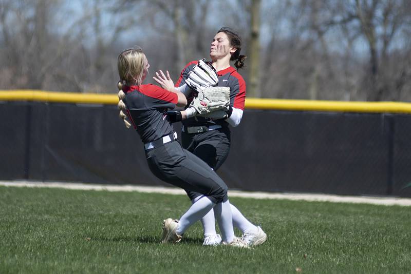 Ottawa's Ryleigh Stehl (left) and Kendall Lowery gently collide on a caught fly ball against Rock Falls Saturday, April 9, 2022.