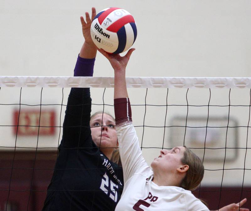 Hampshire’s Hailey Homola, left, battles Prairie Ridge’s Grace Jansen at the net during varsity volleyball on Thursday, Oct. 3, 2024, at Prairie Ridge High School in Crystal Lake.