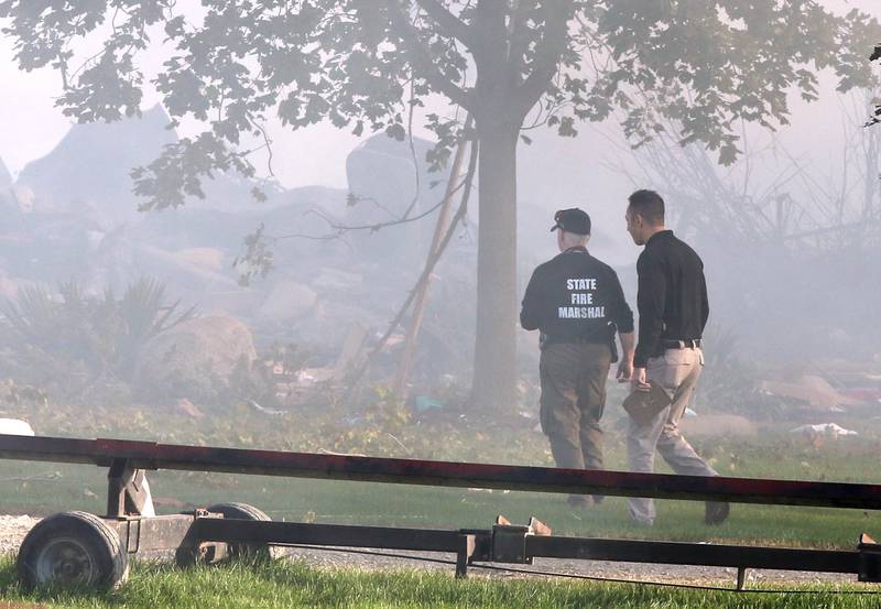 State Fire Marshall staff look at the remnants of a house Tuesday, Oct. 17, 2023, after an explosion at the residence on Goble Road in Earlville. Several fire departments responded to the incident at the single-family home that left one person hospitalized.