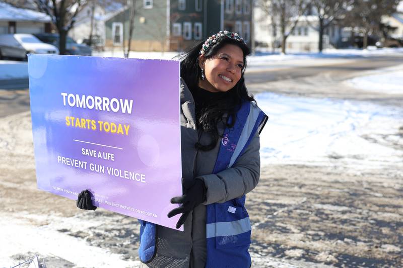 Uri Rodriquez holds a sign along Richards Street for an Illinois Youth & Family Services anti violence rally on Monday, Jan. 26, 2026 in Joliet.