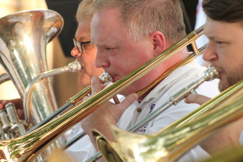 The Dixon Municipal Band trombone section of Tom Cartwright, Jessica Wite, Tom Mosser and Travis Kemmerer perform a selection from Hymn to The Fallen on Friday, July 2, 2021 at the Old Lee County Courthouse in Dixon.