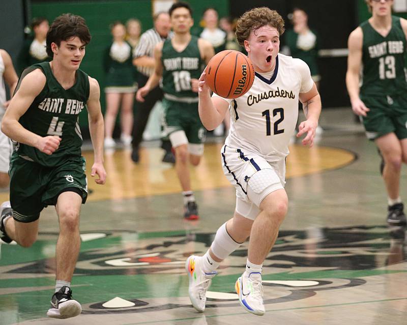 Marquette's Krew Bond runs ahead of St. Bede's John Brady to score on a layup in the Class 1A Regional semifinal on Wednesday, Feb. 22, 2023 at Midland High School.