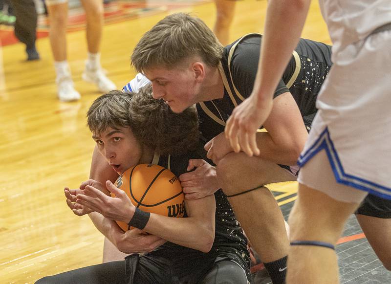 Pecatonica’s Karter Degner secures a loose ball against Newman Tuesday, March 3, 2026, in the 1A sectional semifinal.
