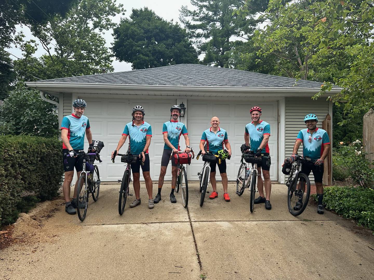 From left to right: Kane County residents Dan Craychee, Jon Burmeister, Cavin McKinley, Jason Schoenfelder, Brian Scott and Nick Jett start their 10-day biking journey across Lake Michigan at Schoenfelder's house in St. Charles. The group departed Wednesday, July 3, and returned Friday, July 12.