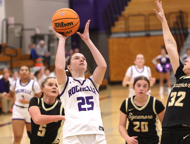 Rochelle's Jaydin Dickey gets a shot up in front of Sycamore's Grace Amptmann Friday, Dec. 5, 2025, during their game at Rochelle High School.