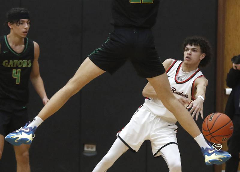 Huntley's Lucas Crosby pass the ball as Crystal Lake South's Tony Santarelli jumps into the air in the passing lane during a Fox Valley Conference boys basketball game Tuesday, Feb.6, 2024, at Huntley High School.