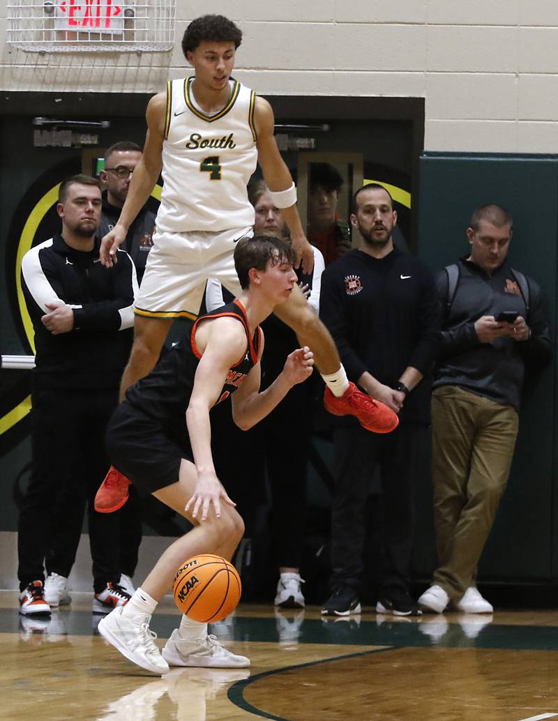 Crystal Lake South's Anthony Demirov watches at McHenry's Dylan Hurckes puts the ball onto the court after Demirov tried to block a three-point shot during a Fox Valley Conference basketball game on Friday, Jan. 31, 2025, at Crystal Lake South High School.