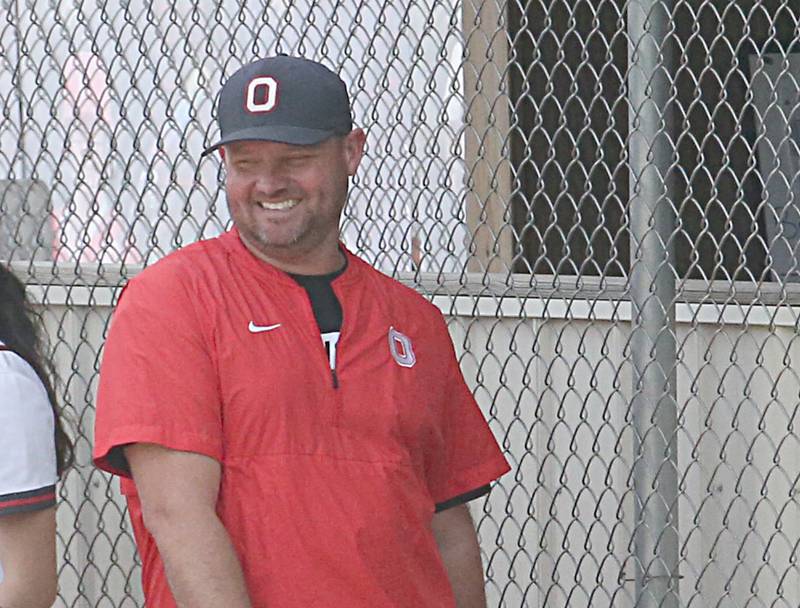 Ottawa head softball coach Adam Lewis smiles while coaching his team against Morris on Monday, May 15, 2023 at Ottawa High School.