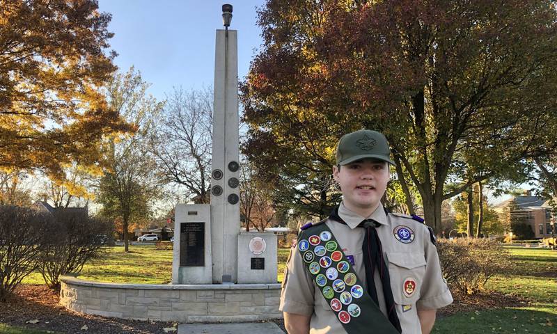 Keegan Wille poses in front of the Eternal Flame statue in Town Square Park in Yorkville, where he will construct benches and a memorial for his eagle scout project.