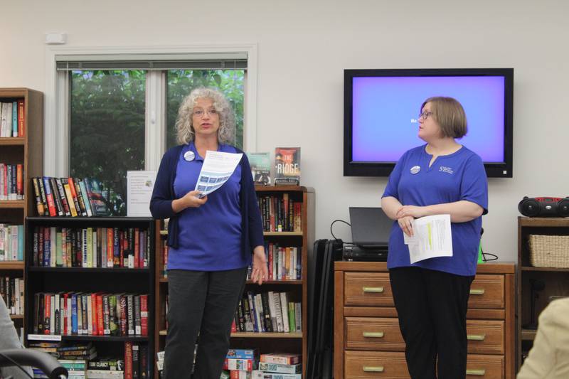 Lisa Geisler, left, and Molly Clough of Senior Services Associates urges people to contact legislators on why they support the Older Americans Act on May 28, 2025 in Crystal Lake.