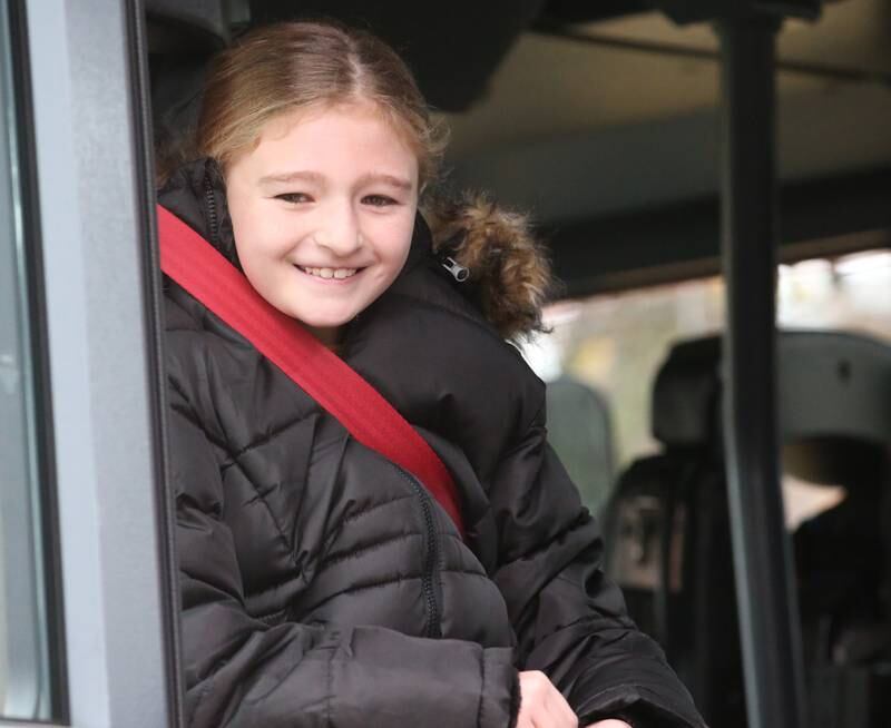 Putnam County Elementary third-grade student Octavia Walter smiles after being picked up to school in a fire engine after  winning the Hennepin Fire Department Escape Floor plan contest on Tuesday, Nov. 21, 2023. Students had to draw a floor plan or map of their home showing all doors and windows. Smoke alarms had to be marked in each plan. A family meeting place was also required to be marked on the drawings. The Hennepin Fire Department has been holding the contest for several years. The department stopped the event during Covid and continued it for the first time since the pandemic this year. The department picks the winning children up on a firetruck and busses them to school.