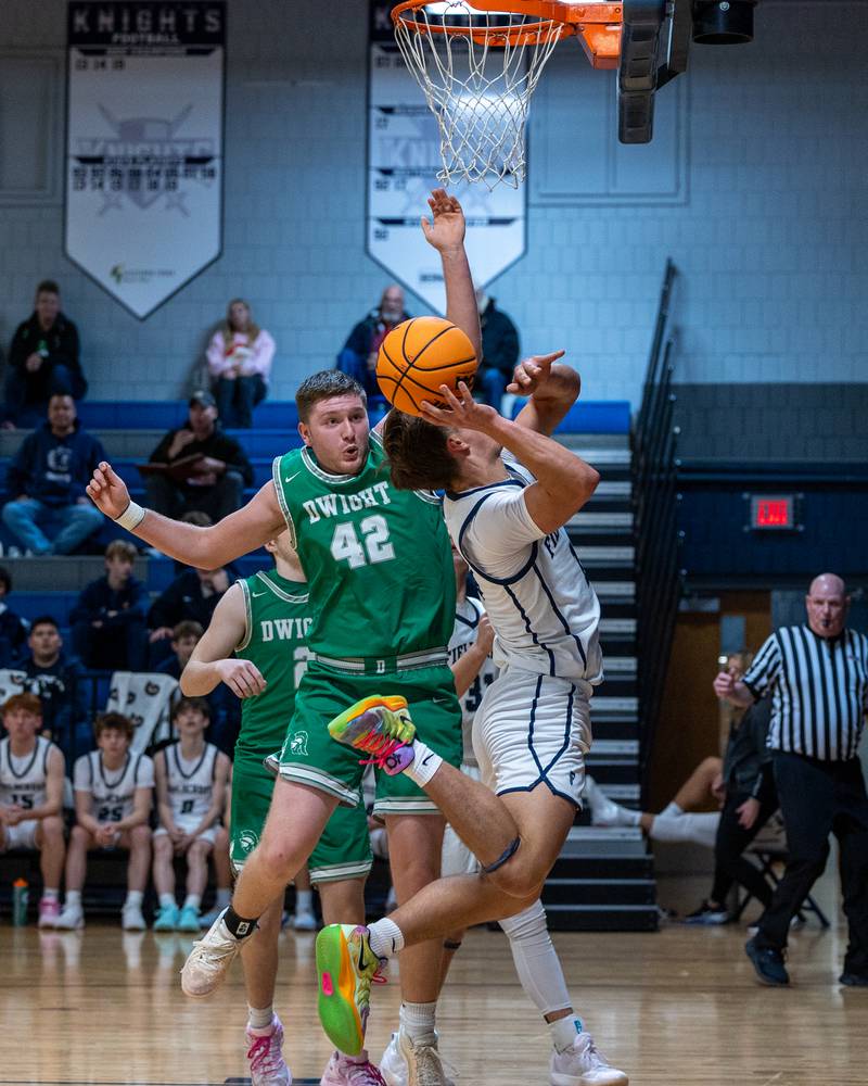 Kash Klendworth (10) of Fieldcrest lays up ball as Jackson Launius (42) of Dwight leaps in attempt to contest on Monday, December 15, 2025 at Fieldcrest High School in Minonk.