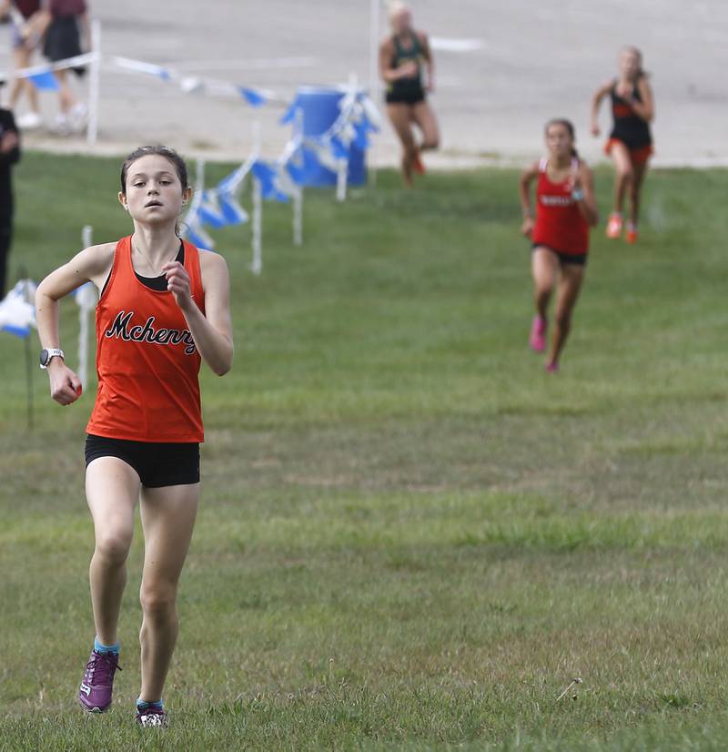 McHenry’s Skyler Balzer runs to the finish line during the girls race of the McHenry County Cross Country Meet Saturday, August 27, 2022, at Emricson Park in Woodstock.