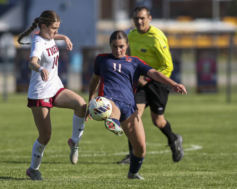 Oswego's Mane Brolley (11) battles Plainfield North's Molly Nelson (10) during a soccer match between Plainfield North at Oswego on Monday, May 11, 2026 in Oswego.