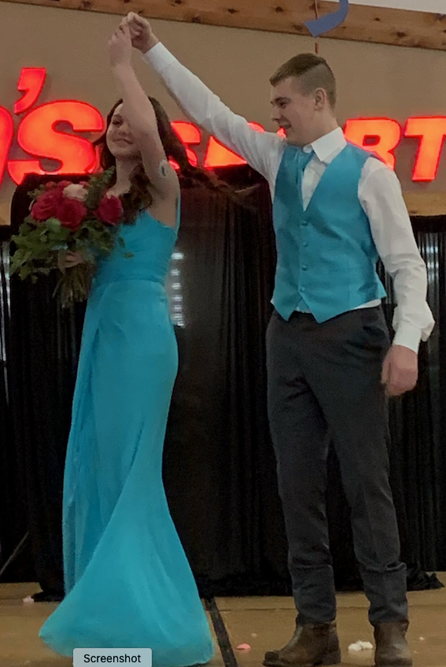 MaryKay Downs and Jaesen Johns model a blue ensemble as part of the Sauk Valley Wedding Expo on Sunday at Northland Mall.