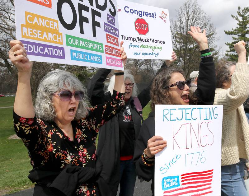 Protesters waves at passing motorists  along Sycamore Road Saturday, April 19, 2025, during a “No Kings” rally and march at Hopkins Park in DeKalb. The group was protesting what they’ve argued is the unlawful and harmful federal policies of President Donald Trump and his administration.