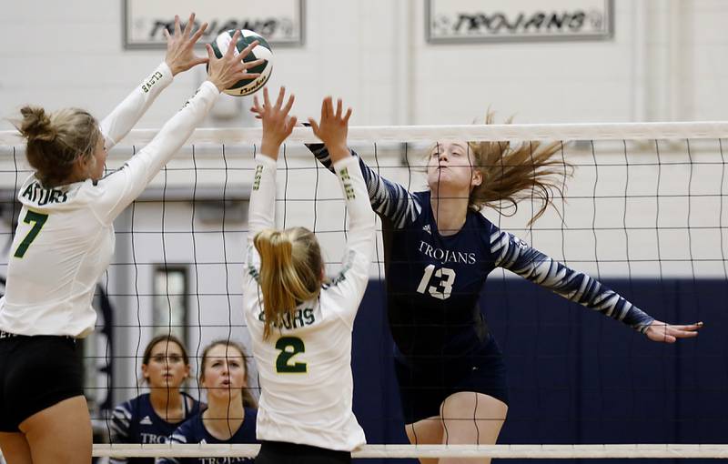 Crystal Lake South’s Gabby Wire, and Kendall Brandt, center, tries to block the spike of Cary-Grove’s Tricia Kennedy during a Fox Valley Conference volleyball match Thursday, Aug. 25, 2022, between Cary-Grove and Crystal Lake South at Cary-Grove High School.