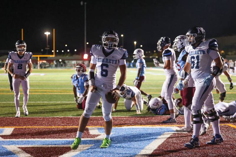 Nazareth's Dylan Wellner, center, celebrates a touchdown during Nazareth's 33-12 victory over Kankakee on Friday, Aug. 29, 2025.