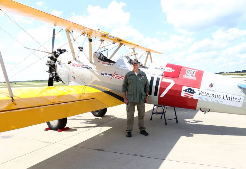 Veteran Lowell Beenenga of Tonica, poses next to a 1942 Boeing Stearman A-75 Primary Trainer during a Veteran Dream Flight on Tuesday, Sept 2, 2025 at the Illinois Valley Regional Airport in Peru.