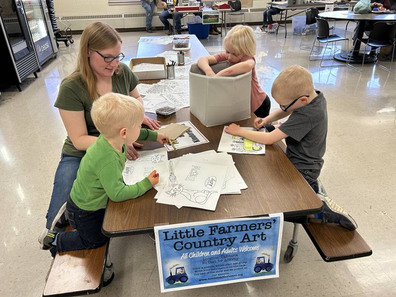 The Bolen family, comprised of Leo 1, Amos 6,  and Annie 4, were busy coloring farm scenes at the ‘Little Farmers’ Country Art’ table under the direction of their mom, Stacy, during the FFA Alumni's Farm Toy and Craft Show on Saturday, March 8, 2025.