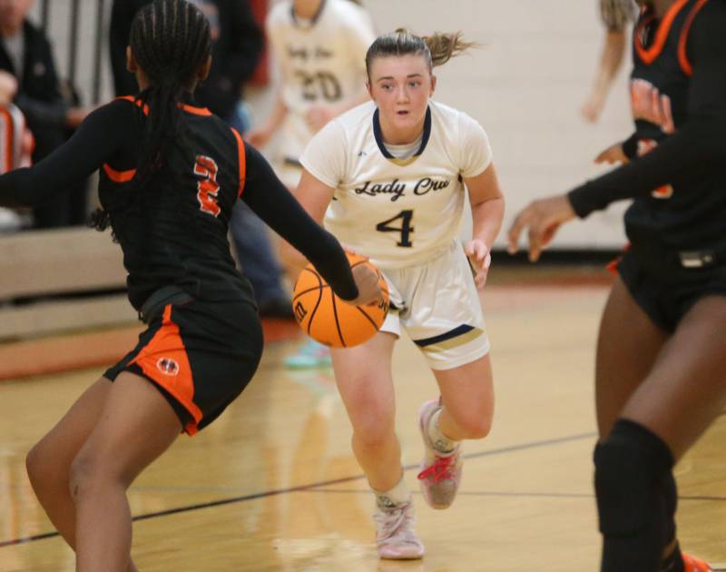 Marquette's Hunter Hopkins looks to pass around Manual's Ma'Kya Maxwell during the Falcon-Irish Thanksgiving Tournament on Monday, Nov. 18, 2024 at Flanagan High School.