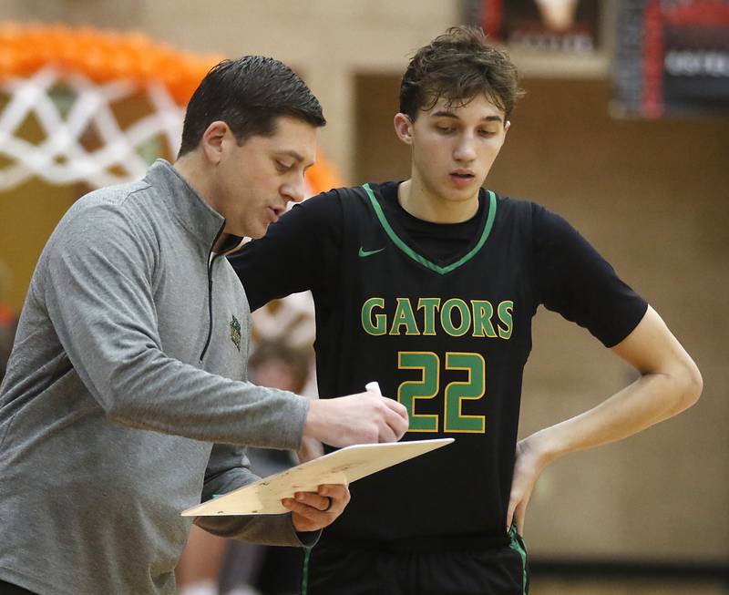 Crystal Lake South Head Coach Matt LePage shows a play to ony Santarelli during a Fox Valley Conference boys basketball game against Huntley Tuesday, Feb.6, 2024, at Huntley High School.