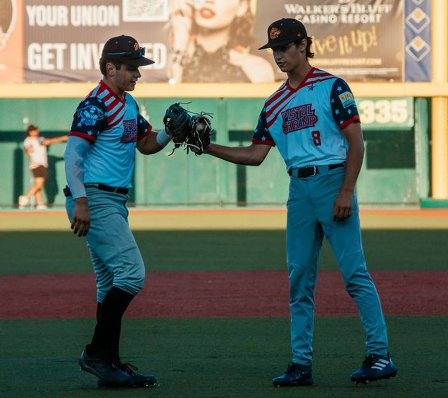 Chris Esquivel (left) and Daniel Strohm high five during the Illinois Valley Pistol Shrimp's 7-5 loss to the Thrillville Thrillbillies on Friday, July 5, 2024 in Marion, Ill.