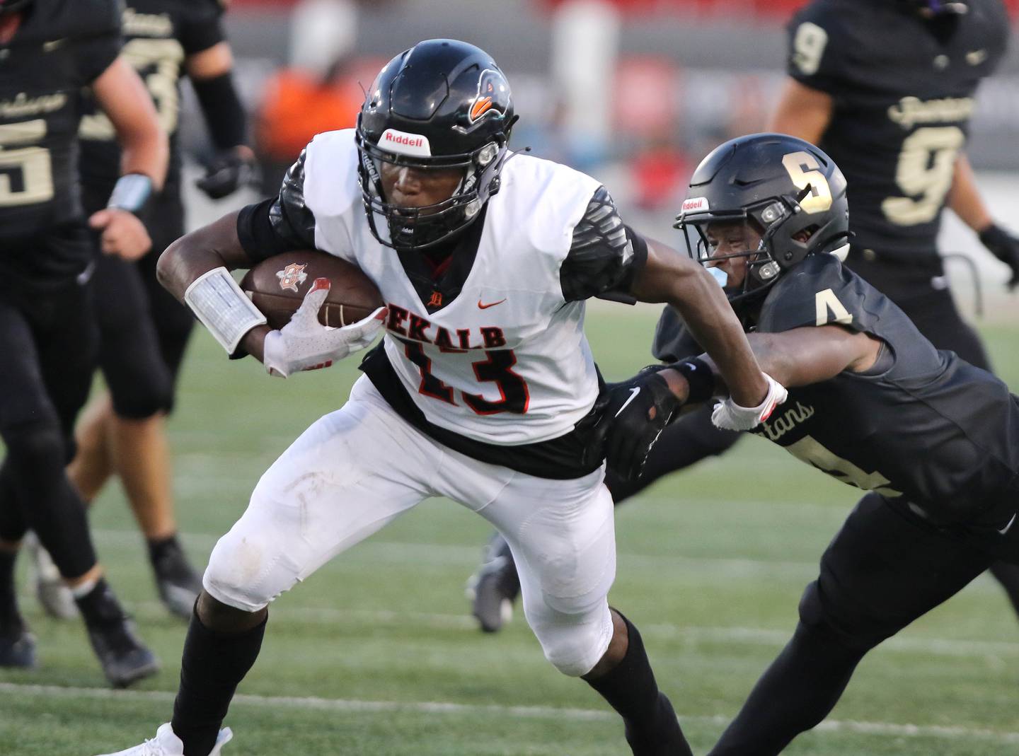 DeKalb’s Davon Grant gets away from Sycamore's Tyler Curtis during the First National Challenge game Friday, Aug. 25, 2023, in Huskie Stadium at Northern Illinois University in DeKalb.