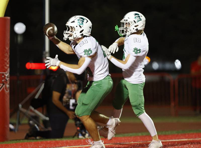York's Henry Duda (26) and Colby Baird (18) celebrate a touchdown during the varsity football game between York and Hinsdale Central on Friday, Oct. 3, 2025 in Hinsdale, IL.