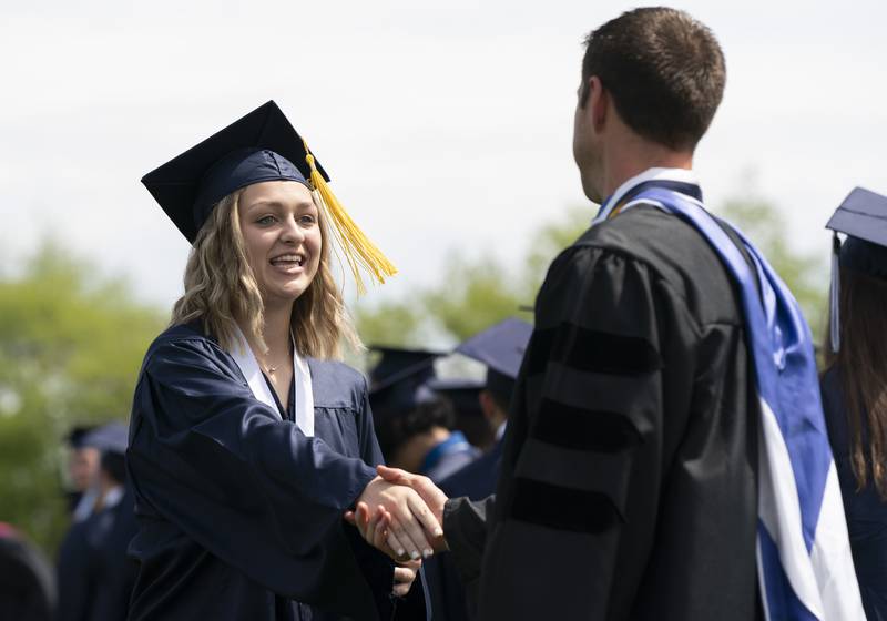 Graduate Kate Barklow shakes hands with Principal Neil Lesinski after receiving her diploma during a graduation ceremony for the class of 2022 on Saturday, May 14, 2022, at Cary-Grove High School in Cary.