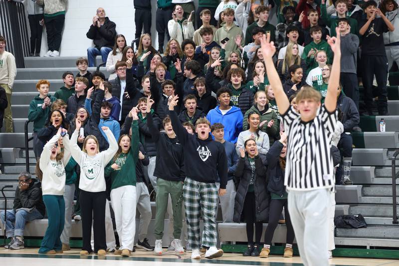 The Bishop McNamara student section cheers as varsity basketball player Coen Demack signals a good 3-pointer during River Valley Special Rec's game against Lincolnway Special Recreation Association on Friday, Jan. 30, 2026.