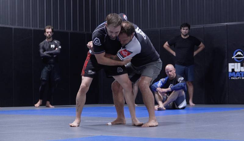Jeff Curran (right) demonstrates a takedown on Justin Seeberger during a group class at Team Curran in Crystal Lake as Curran prepares Seeberger for his upcoming match at the inaugural Jeff Curran Invitational.
