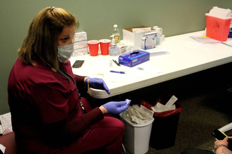 Kendall County Community Health Director Terri Olson explained the effects of receiving the second dose of the COVID-19 vaccine to a county resident at the health department's vaccination site in Yorkville Jan. 28.