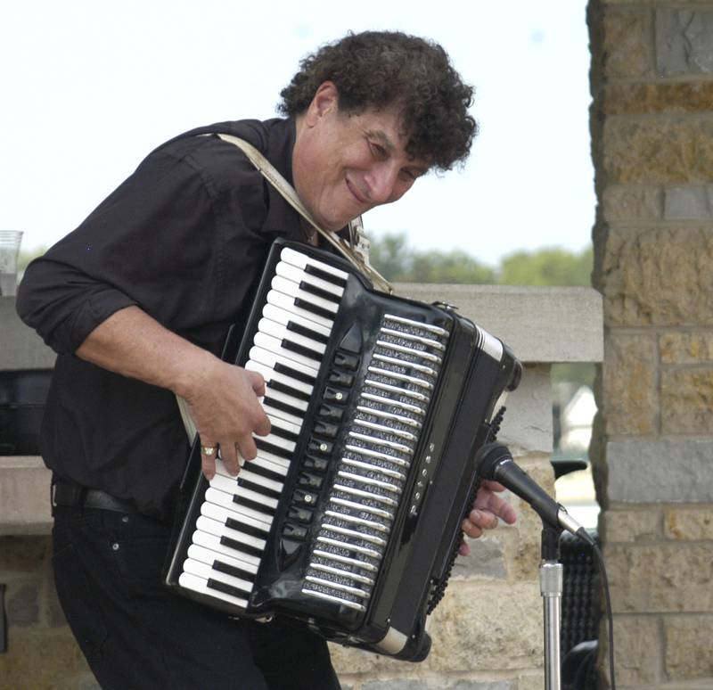 Accordionist  Lenny Leto of Dixon plays to the crowd at Venetian Night. Venetian Night in Dixon featured magicians, street performers, face painting, a spaghetti eating contest, mini boat races, a drone light show and more. The Discover Dixon event was held along the riverfront in Dixon on Aug. 9, 2025.