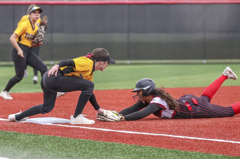 Yorkville's Liv Lathen (5) slides into the tag at third during softball game between Joliet West at Yorkville on Wednesday, April 30, 2025 in Yorkville.